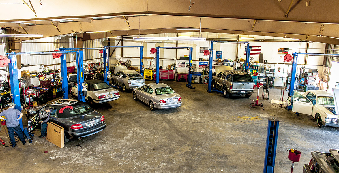 Wide view of the shop floor with cars on lifts