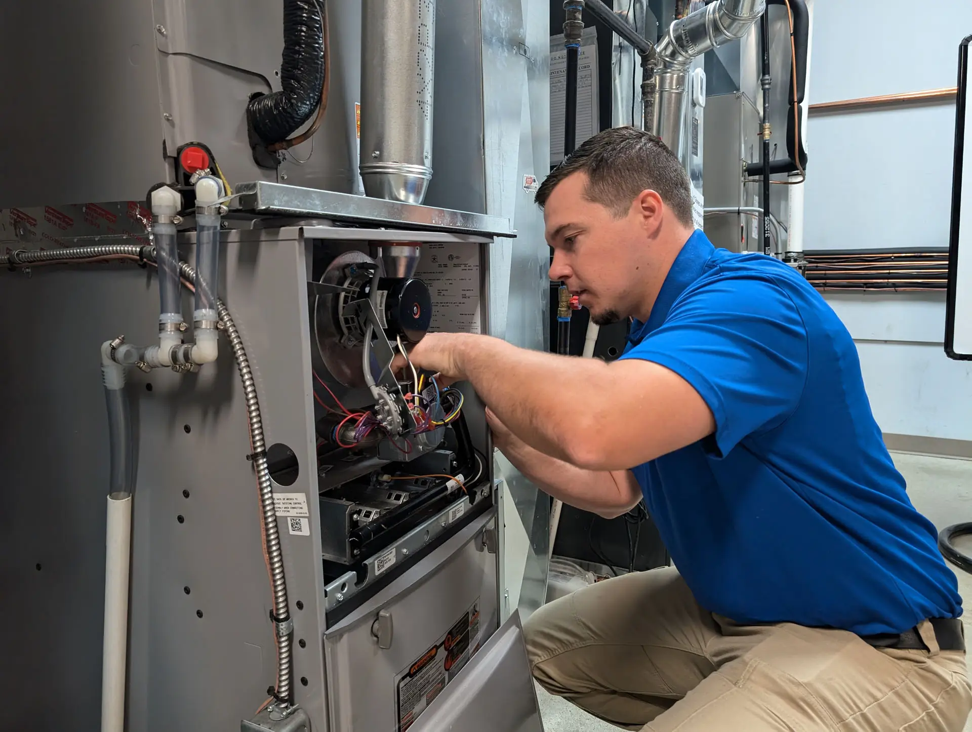 HVAC technician repairing a furnace