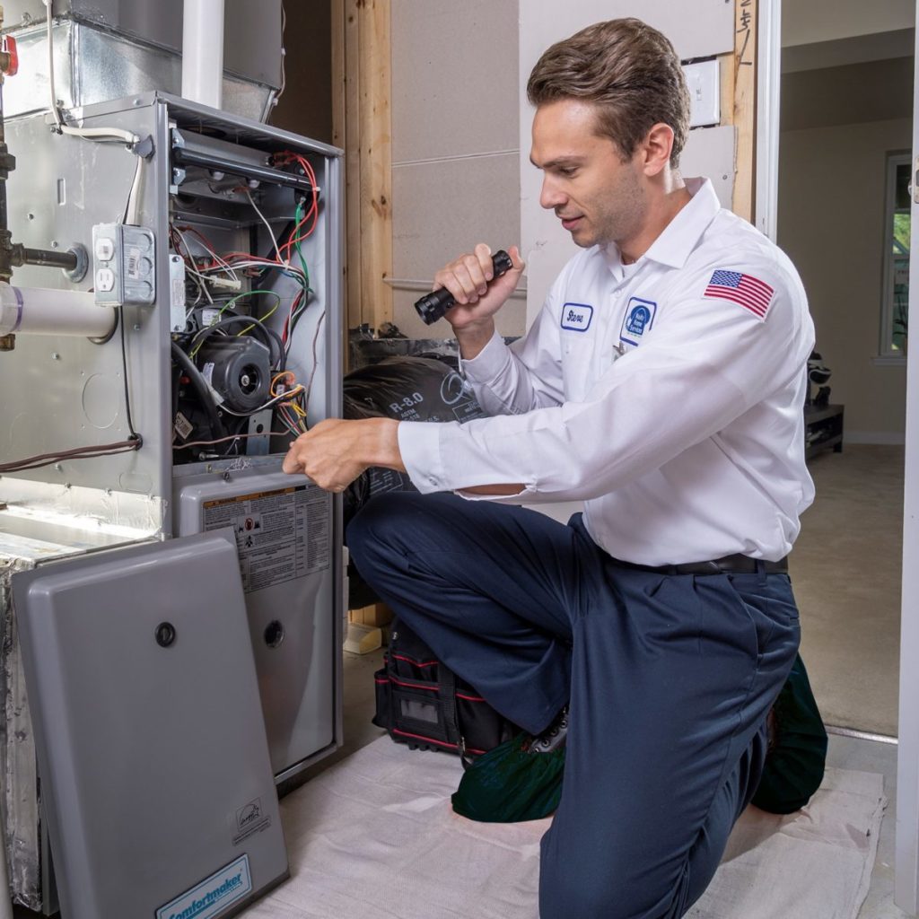 HVAC technician servicing a heating unit