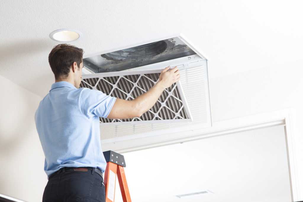 HVAC technician changing an air filter