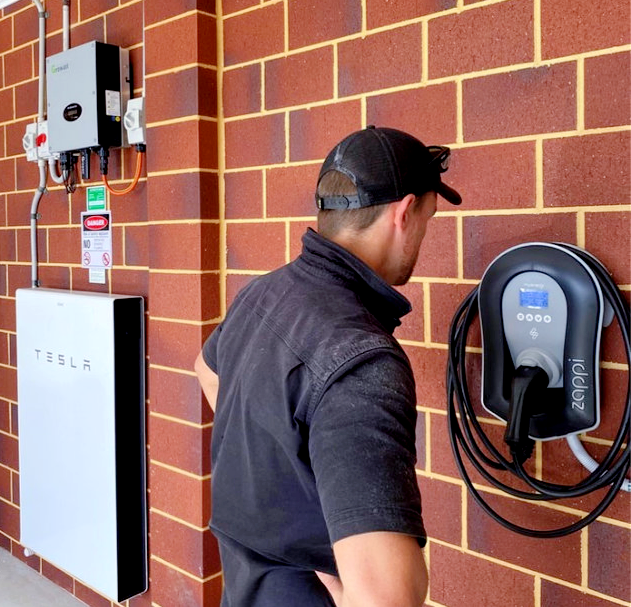 Home EV charger and battery storage installed on an exterior wall