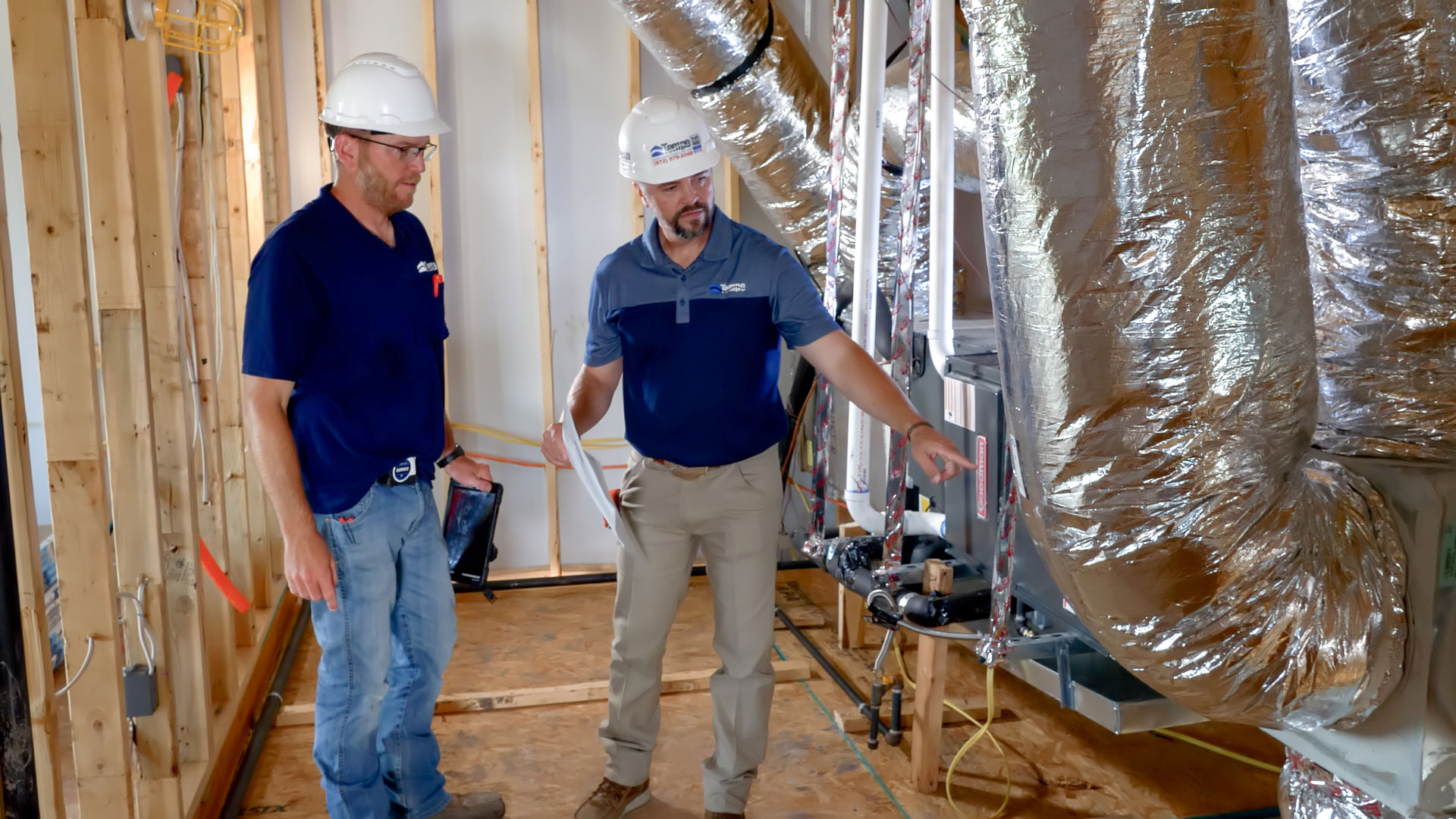 HVAC contractors reviewing new construction ductwork