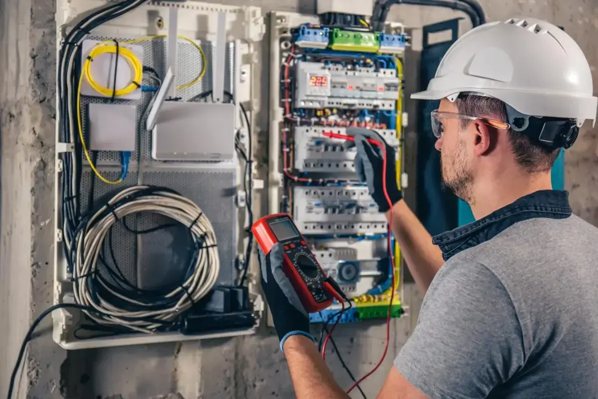 Technician testing a low-voltage smart home panel